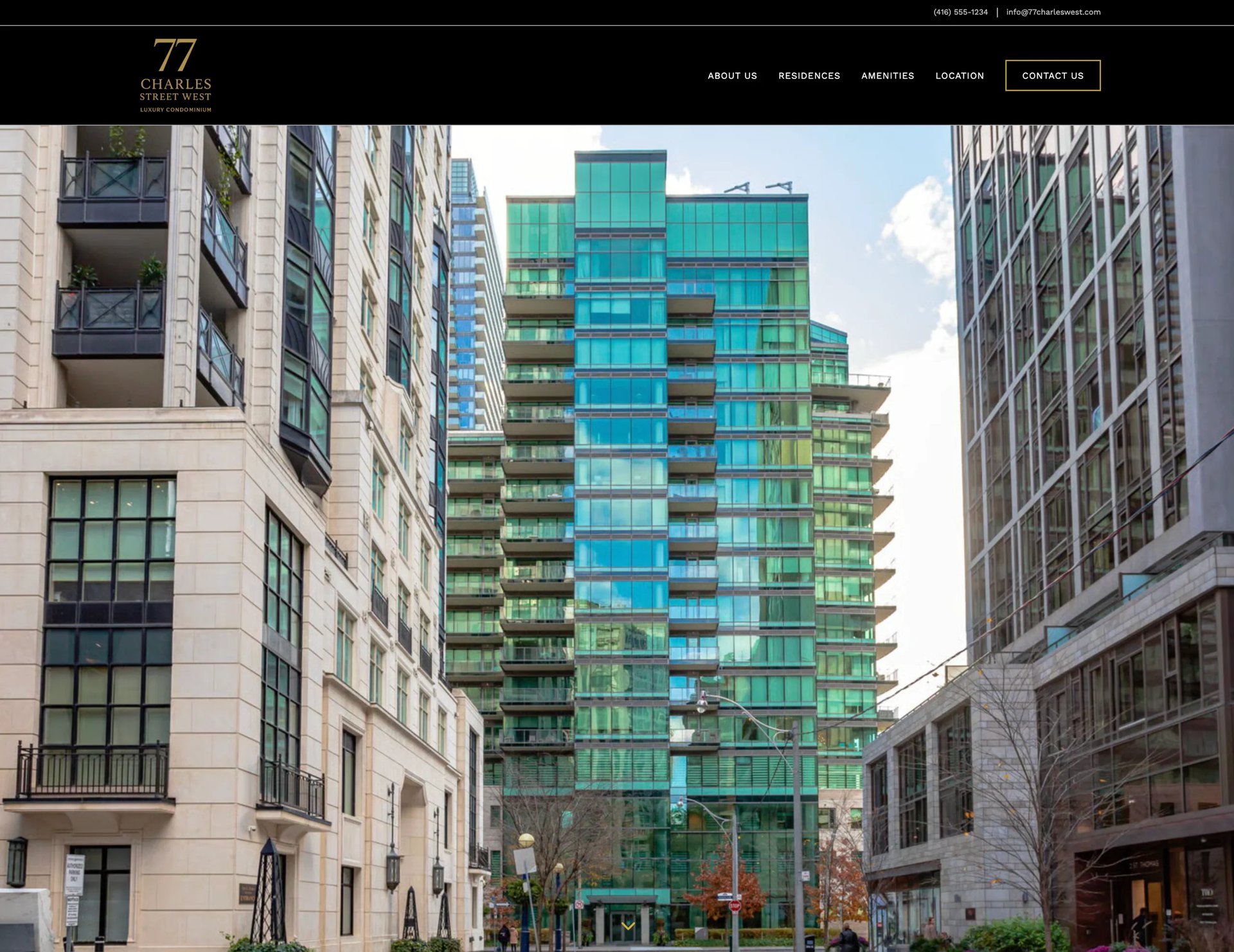 Modern green glass residential tower surrounded by historic stone buildings in an urban setting