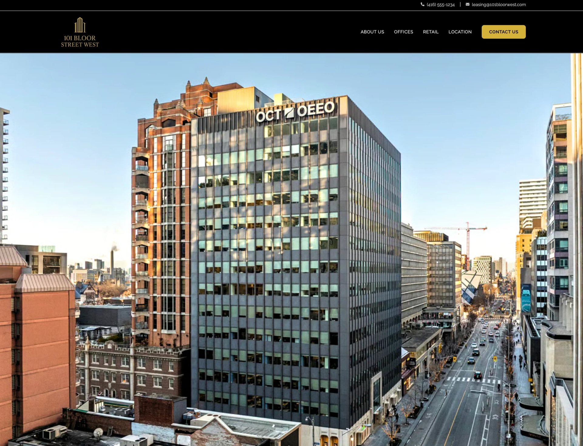 Aerial view of a large Deco building with signage, surrounded by other office and residential buildings in an urban downtown setting
